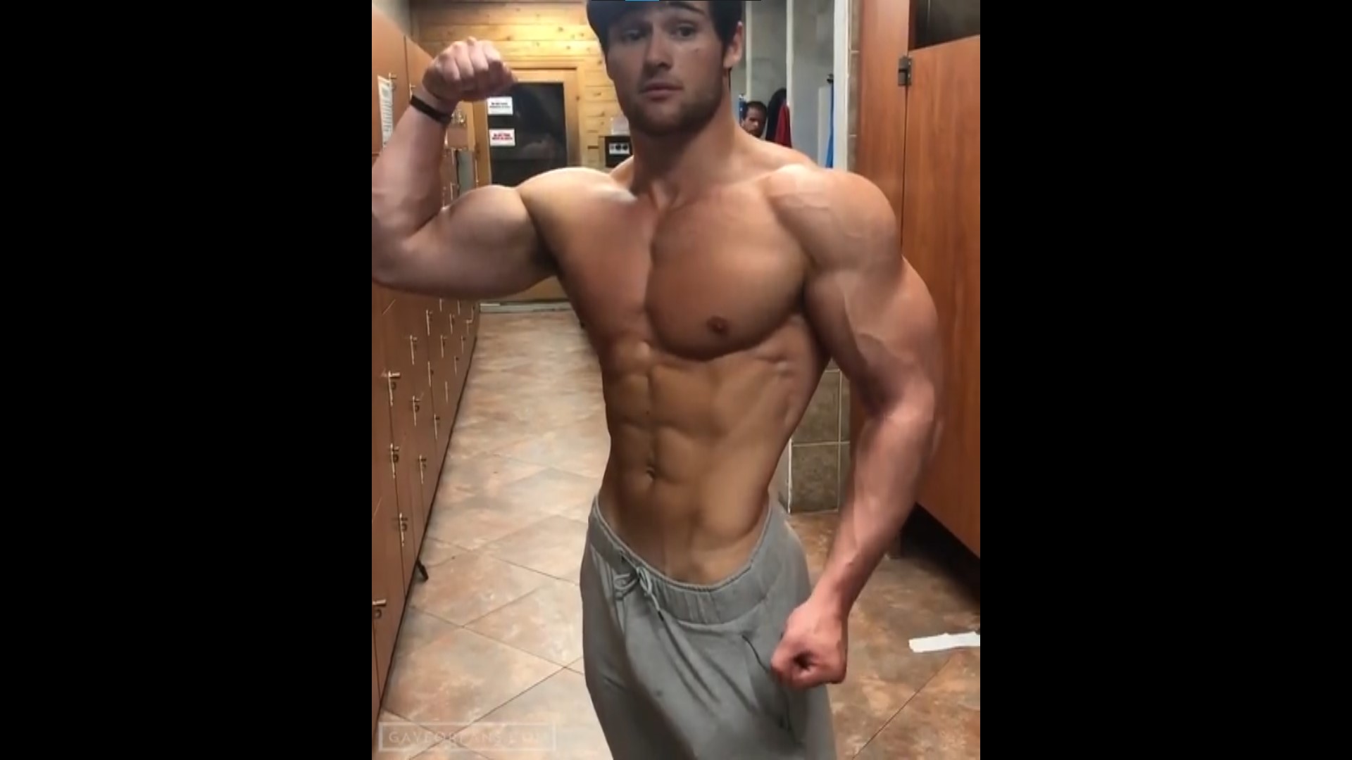 Dylan McKenna flexing at gym